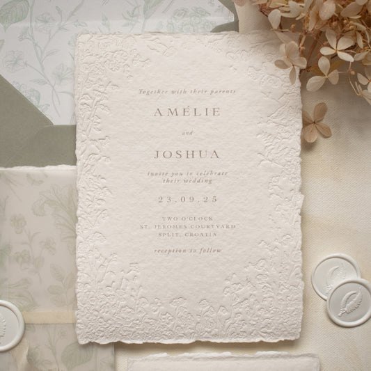 blind letterpress wedding invitation with floral detailing on handmade cotton paper, paired with sage green envelope and floral printed envelope liner