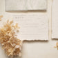 wedding rsvp card with blind letterpress leaf vine printed on handmade cotton paper and styled with beige dried flowers